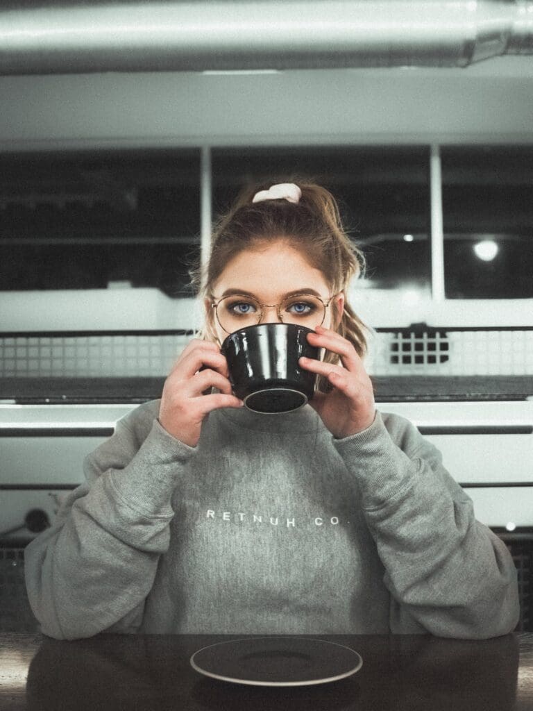 A woman holding a cup of coffee in her hands.