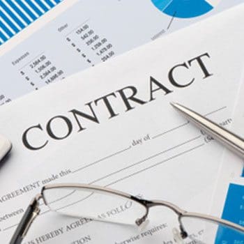 A contract is sitting on top of some papers.